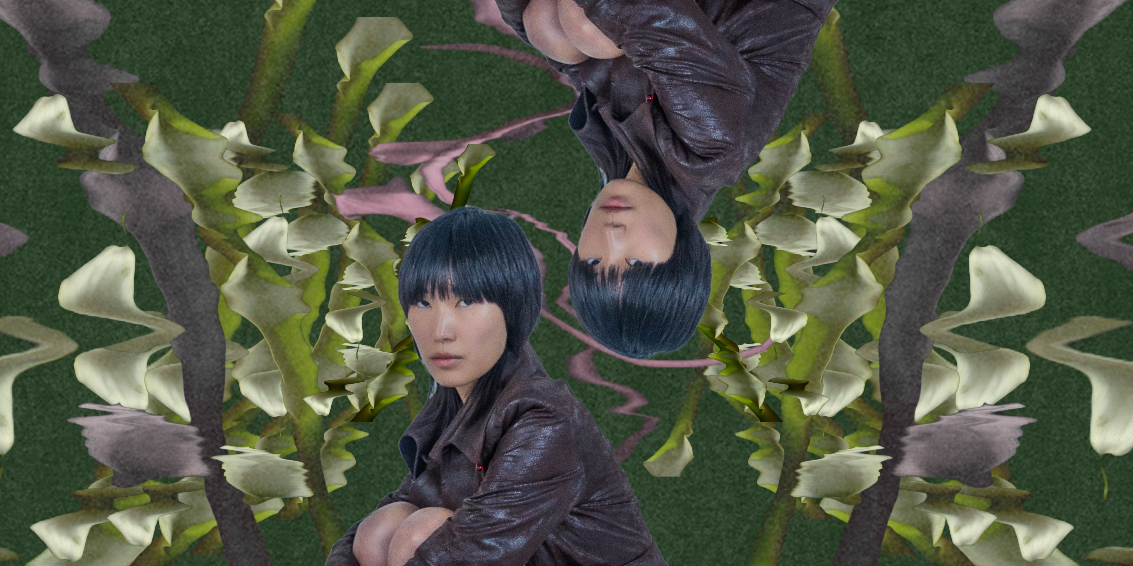 Model with black hair and a brown jacket mirrored edit among green leaves.